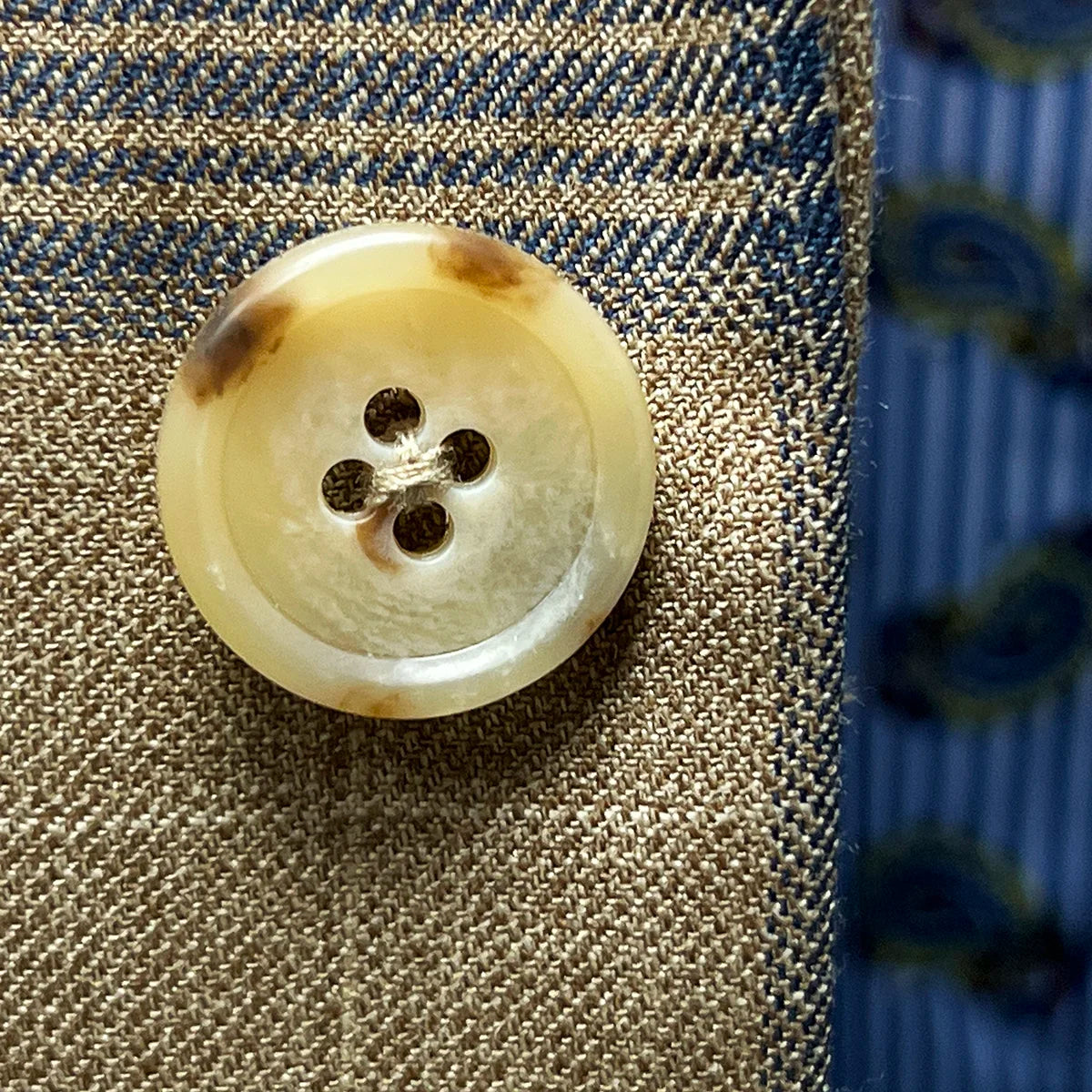 Macro shot of tan horn buttons showing natural marble patterns