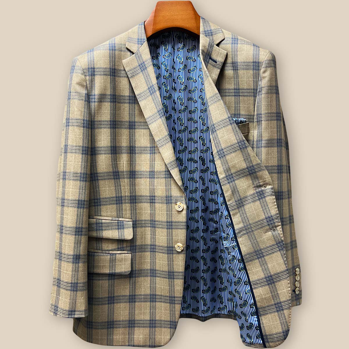 Interior left side view of sport coat showing blue striped paisley lining and inner pocket construction