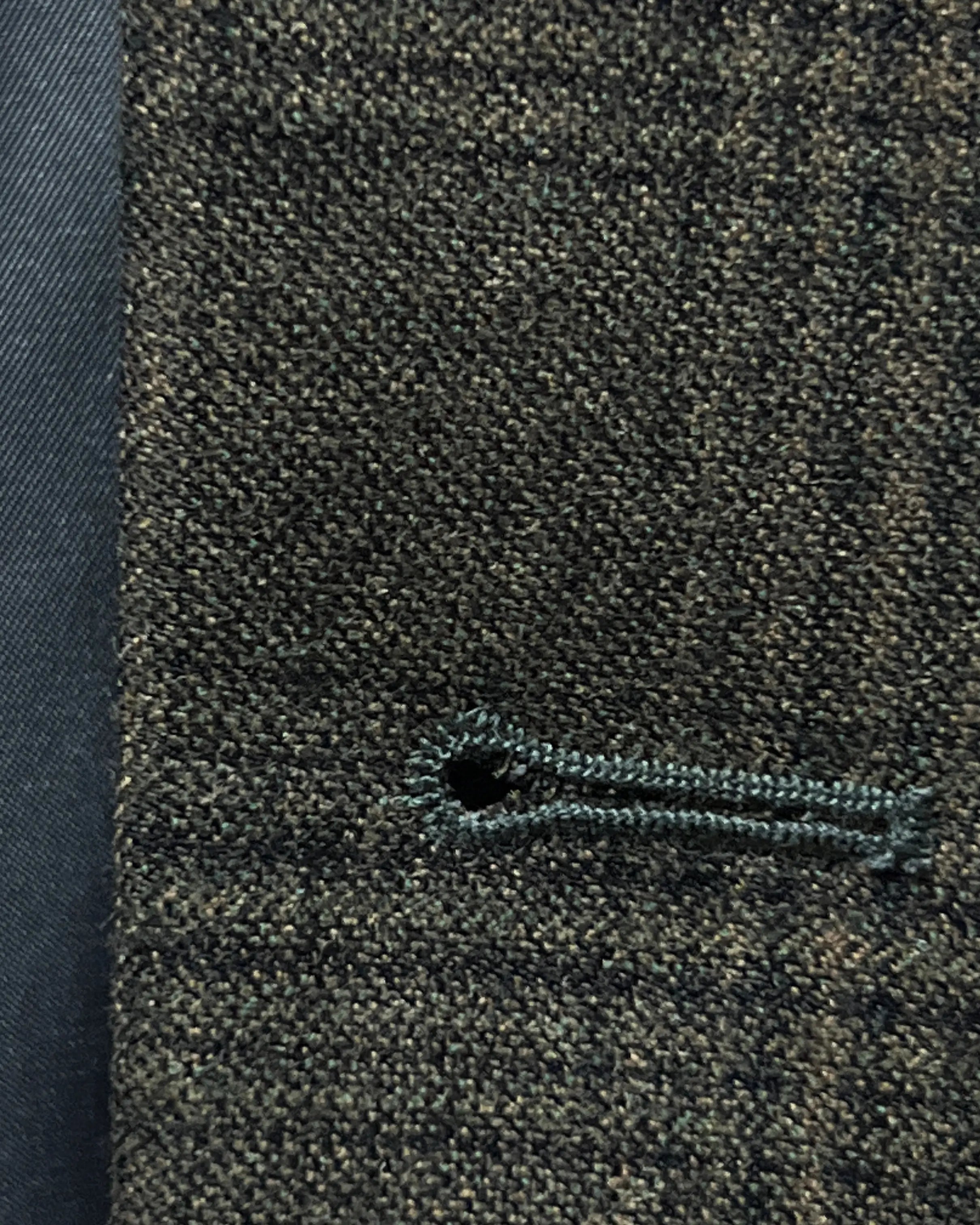 Front buttonhole close up of charcoal brown melange tonal Glen Plaid men's sport coat showing clean tailored buttonhole construction.