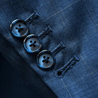 Close-up of sleeve showing functional buttonholes with navy horn marble buttons