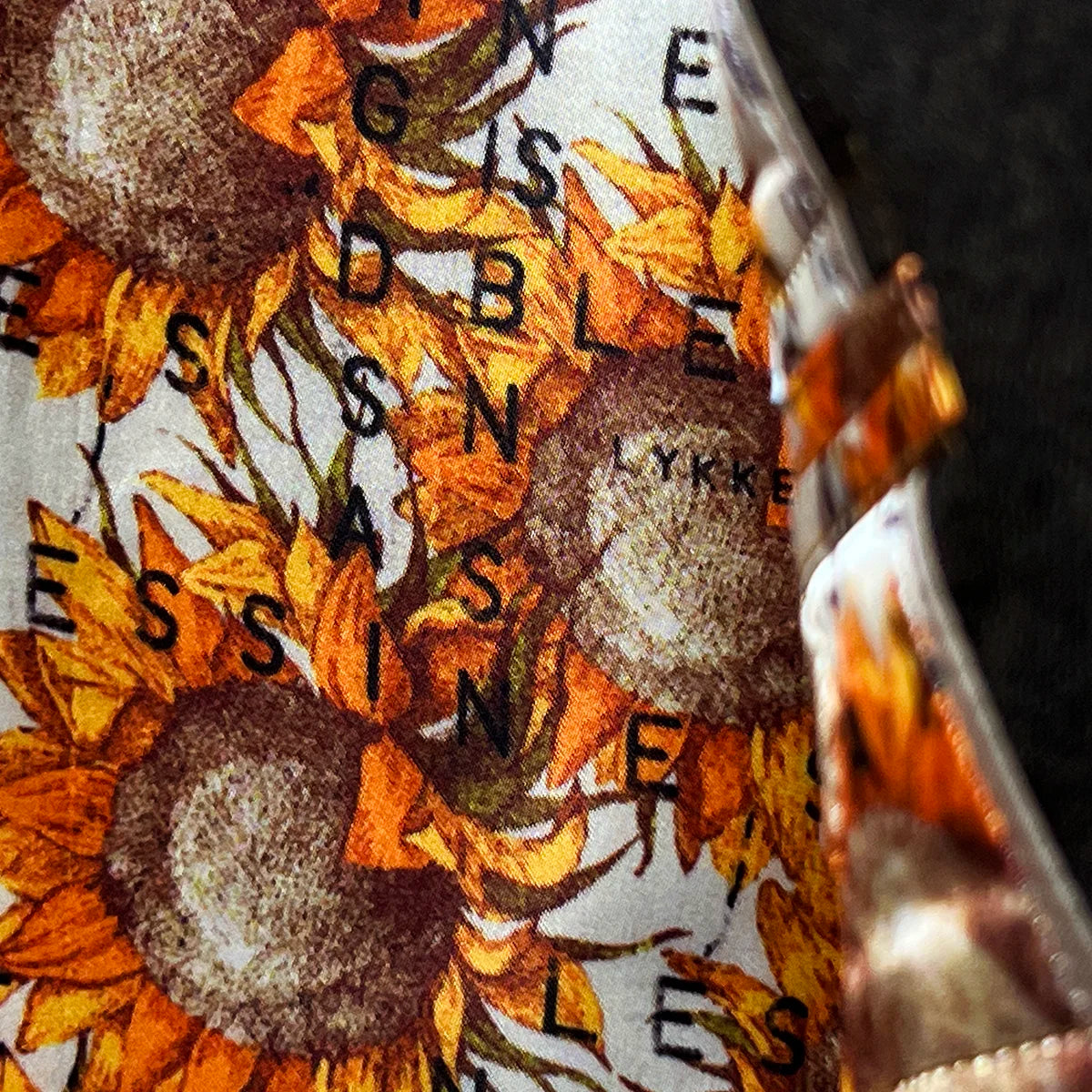 Colorful flash lining detail visible at jacket cuffs and vents in sunflower floral pattern