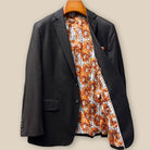 Interior left side of dark brown plain weave suit jacket displaying sunflower floral fancy lining with inner pocket