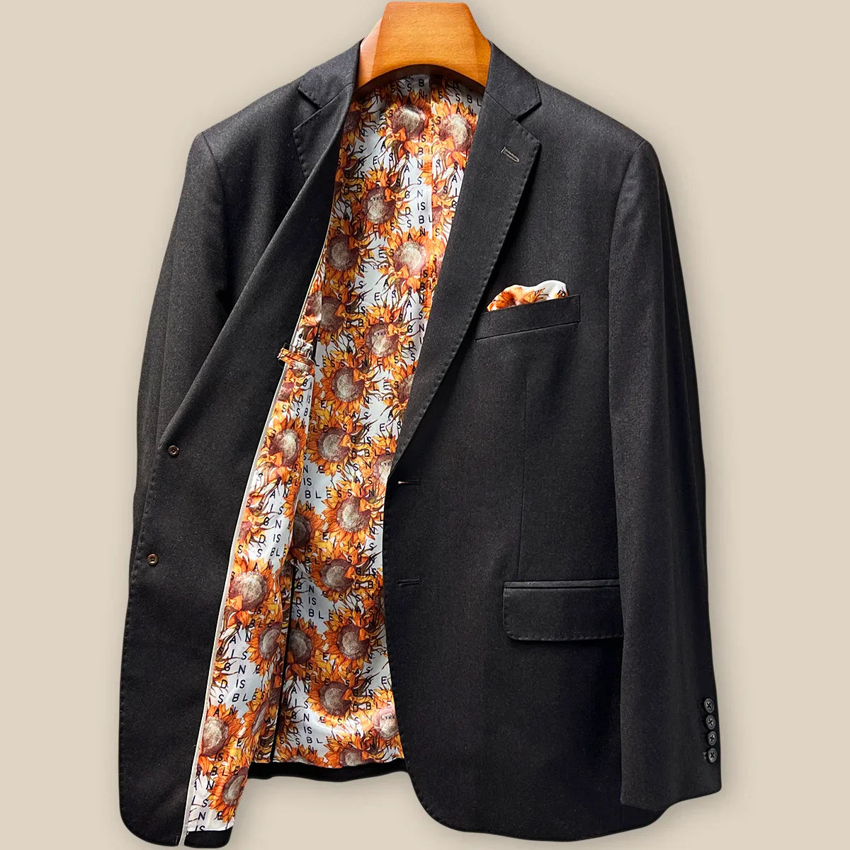 Interior right side of dark brown plain weave suit jacket revealing sunflower floral lining and internal construction details