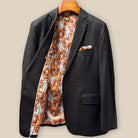 Interior right side of dark brown plain weave suit jacket revealing sunflower floral lining and internal construction details