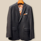 Close-up view of dark brown plain weave suit jacket showing contrast medium brown accent buttonhole with hand-finished stitching detail