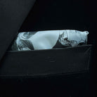 Breast pocket of black silk velvet formalwear tuxedo jacket with built-in pocket square holder and hand-finished edges