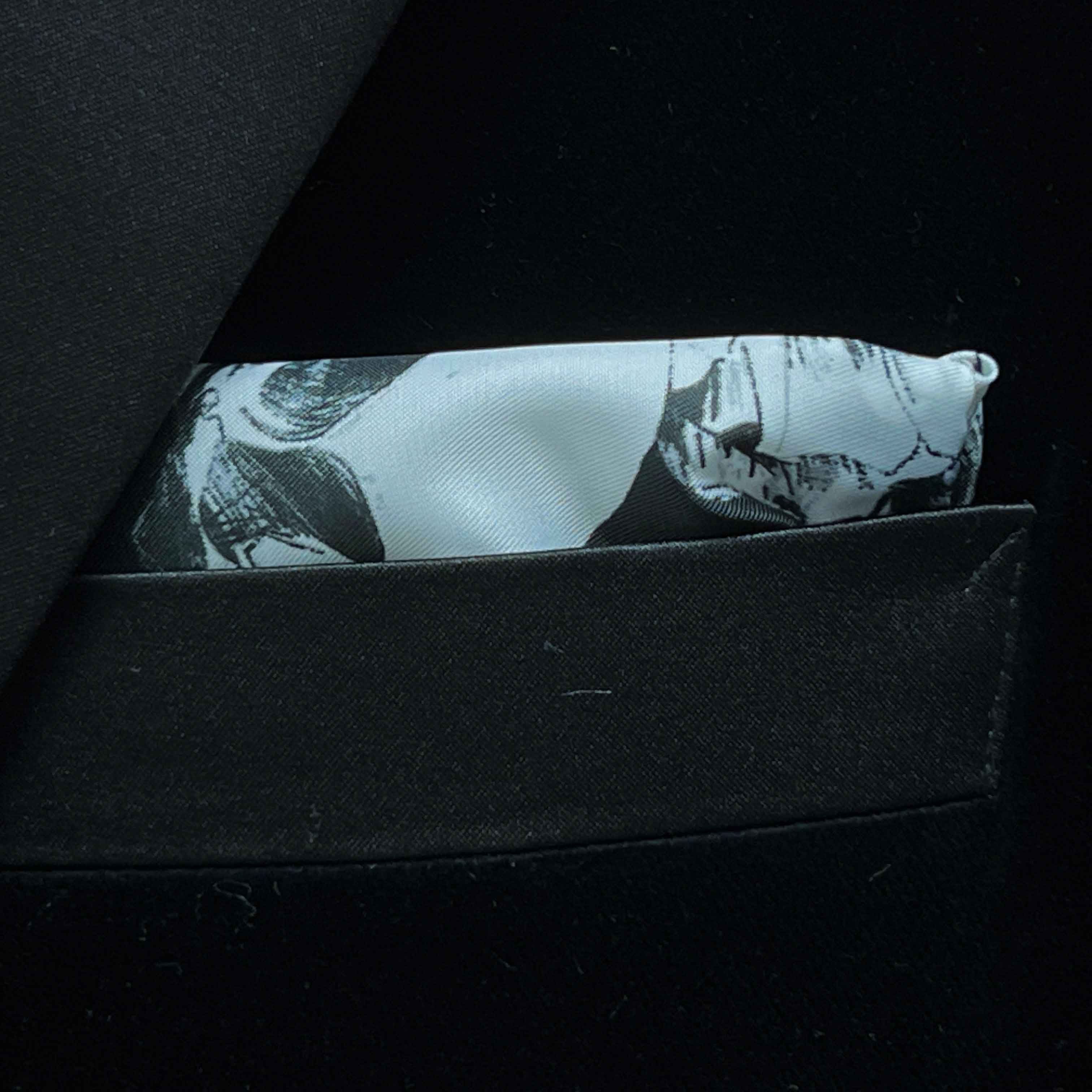 Breast pocket of black silk velvet formalwear tuxedo jacket with built-in pocket square holder and hand-finished edges