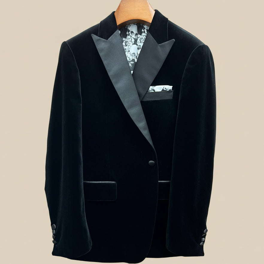 Front button panel of black silk velvet formalwear tuxedo jacket featuring black silk satin covered buttons and hand pick stitching