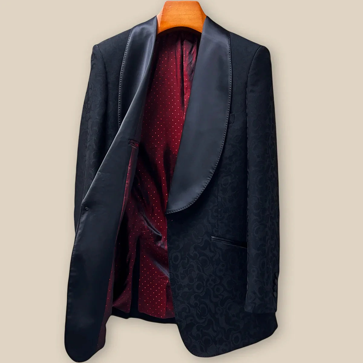 Interior left side of black self floral tuxedo jacket displaying red on red polka dot lining with inner pocket
