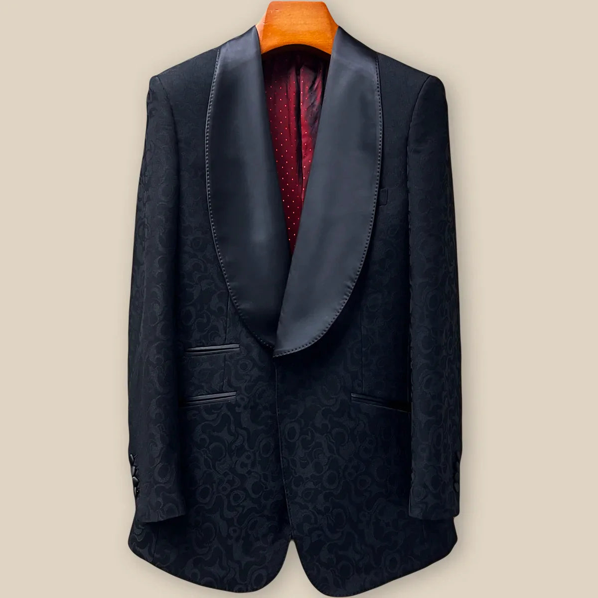 Front button panel of black self floral tuxedo jacket featuring black silk satin covered buttons and hand pick stitching