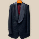 Front button panel of black self floral tuxedo jacket featuring black silk satin covered buttons and hand pick stitching