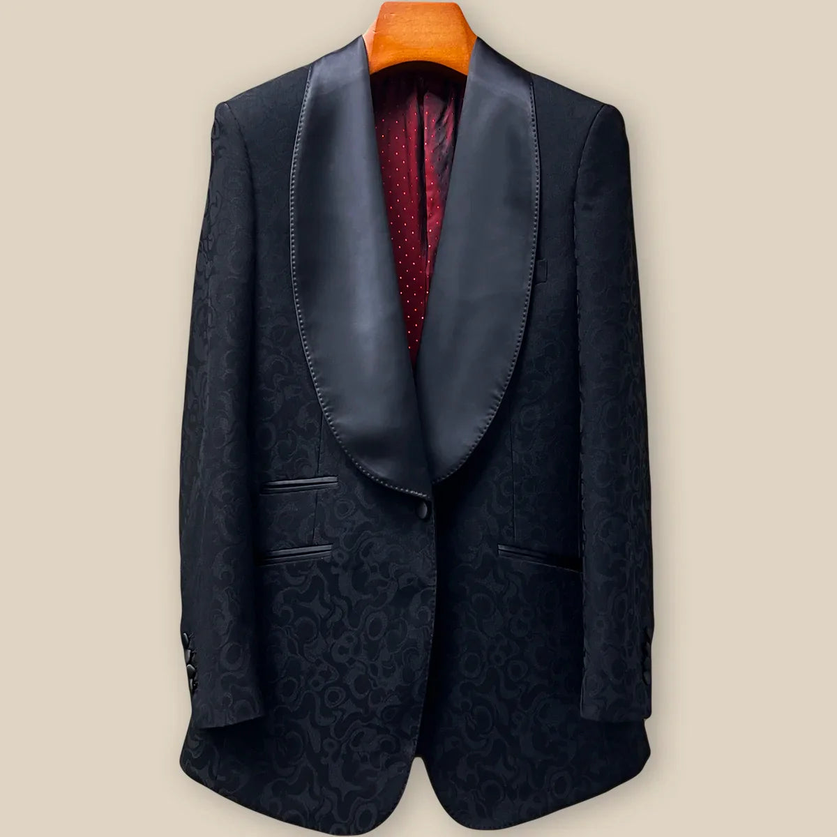 Close-up view of black self floral tuxedo jacket showing contrast black satin accent buttonhole with hand-finished pick stitching detail