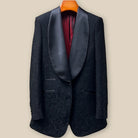 Close-up view of black self floral tuxedo jacket showing contrast black satin accent buttonhole with hand-finished pick stitching detail