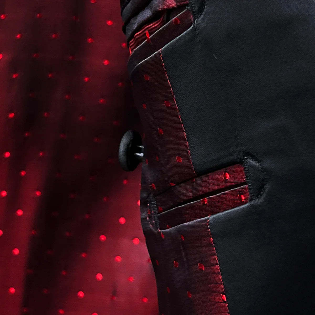 Interior lining detail showing vibrant red on red polka dot pattern with contrast stitching