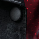 Close-up of black silk satin covered buttons on self floral tuxedo jacket showing lustrous finish