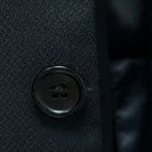 Detailed view of black horn buttons on a Westwood Hart self-textured jacquard suit jacket