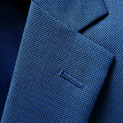 Close-up of the notch lapel construction and stitching detail