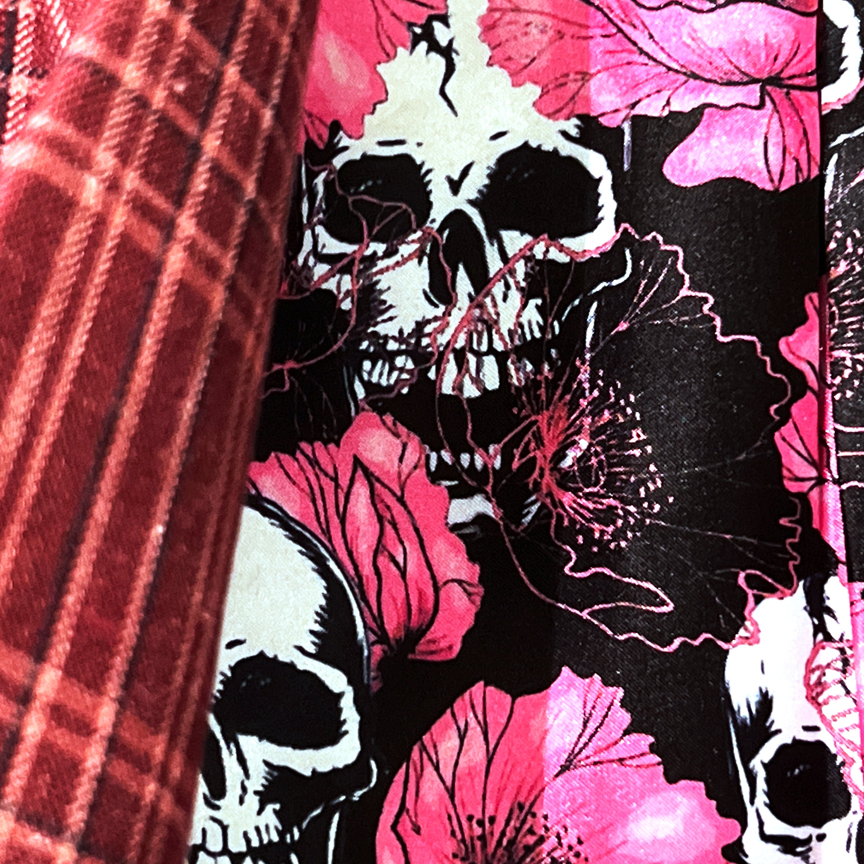 Colorful flash lining detail visible at jacket cuffs and vents in black with pink floral and skulls pattern