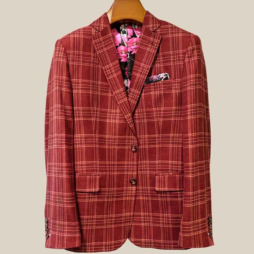 Front button panel of burgundy plaid sport coat featuring burgundy marble buttons and hand pick stitching