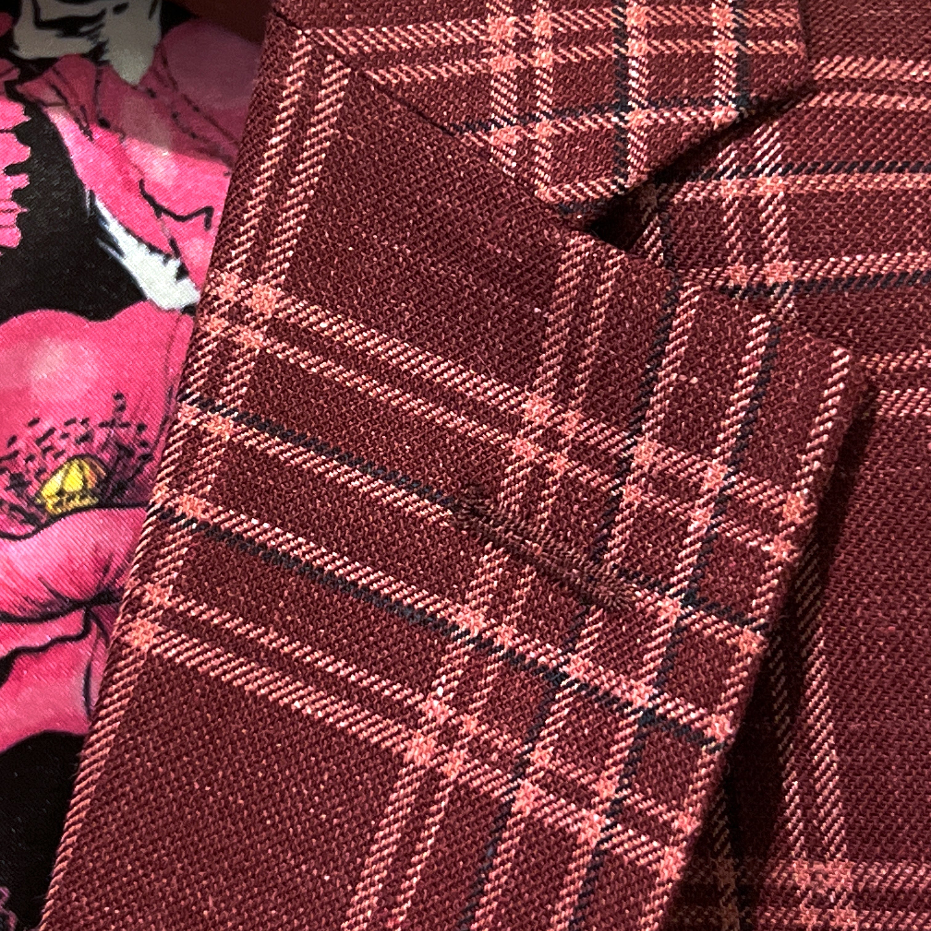 Classic notch lapel detail on burgundy plaid sport coat showing hand pick stitching and plaid check pattern