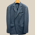 Close-up view of charcoal grey herringbone sport coat showing contrast edge pick stitching detail on buttonhole panel