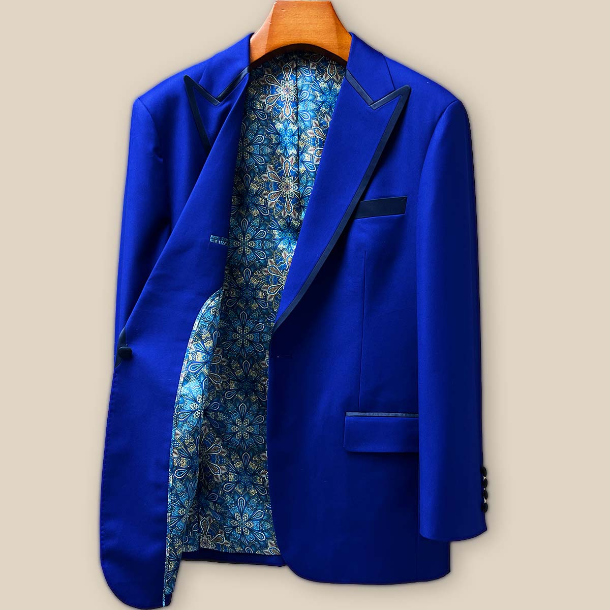 Interior right side view of cobalt blue tuxedo jacket showing meticulous construction, hidden pockets, and the continuation of geometric pattern lining