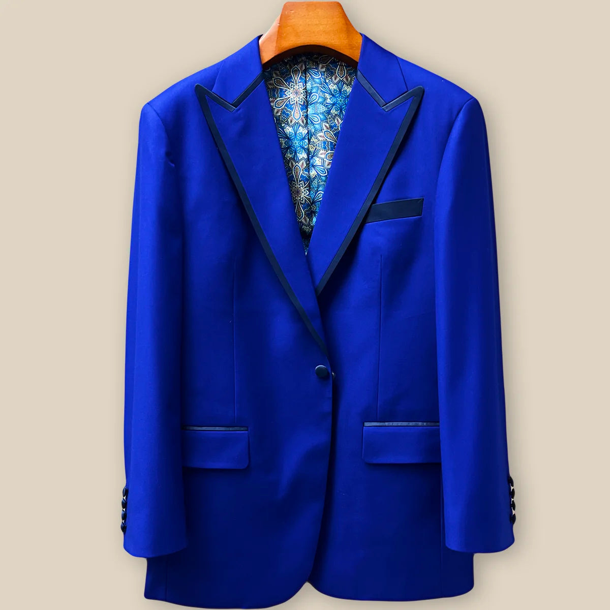 Detailed view of navy silk satin covered buttons on a cobalt blue Westwood Hart tuxedo jacket, demonstrating elegant coordination with lapel trim