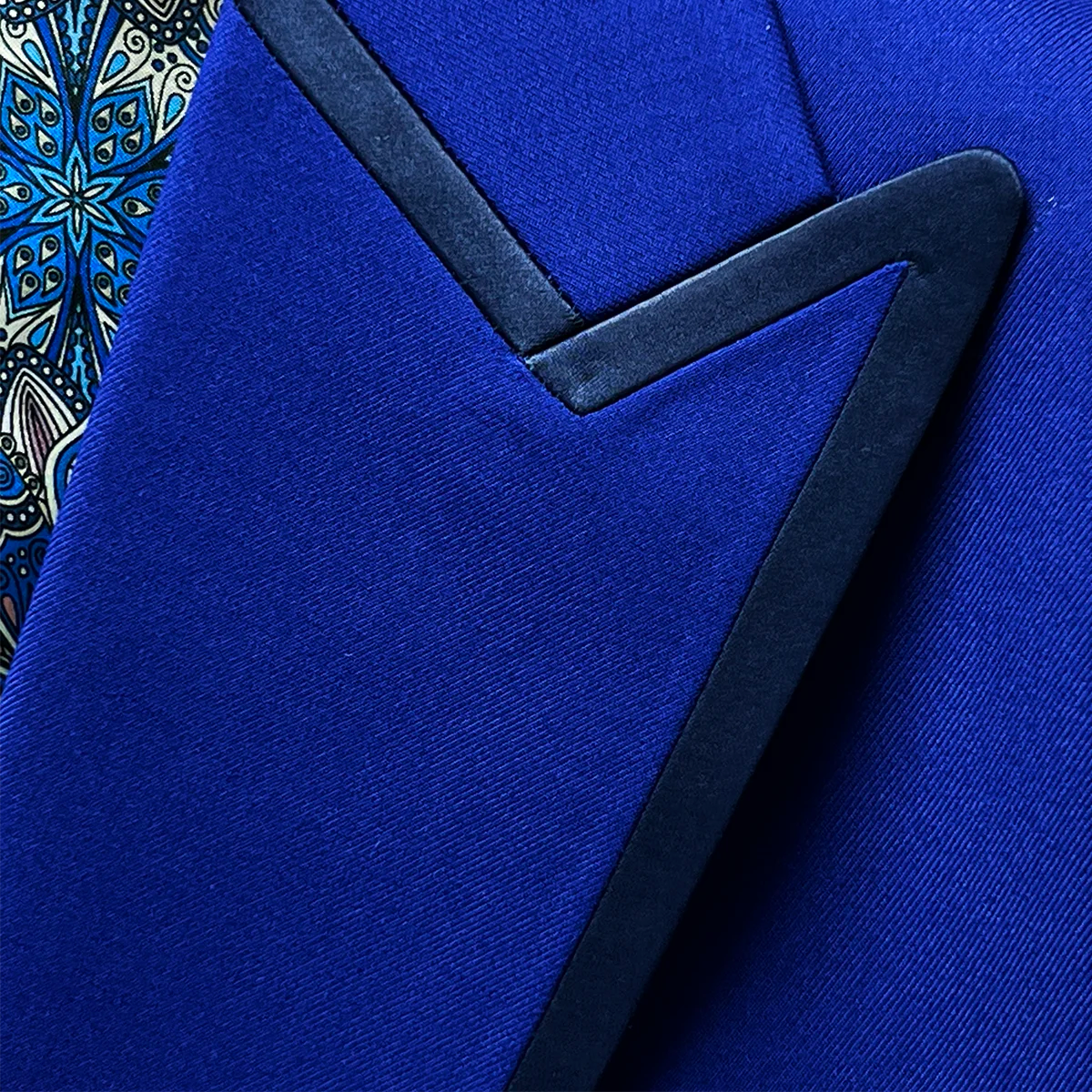 Elegant peak lapel of the cobalt blue Westwood Hart tuxedo with navy silk satin trimming, showcasing the classic formal design choice