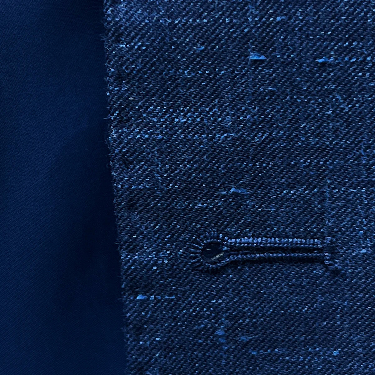 Macro shot of hand pick stitching detail around buttonholes