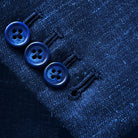 Close-up of working sleeve buttonholes with navy horn buttons