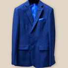 Close-up of dark blue Westwood Hart suit jacket showing windowpane pattern and royal blue accent buttonhole on sleeve