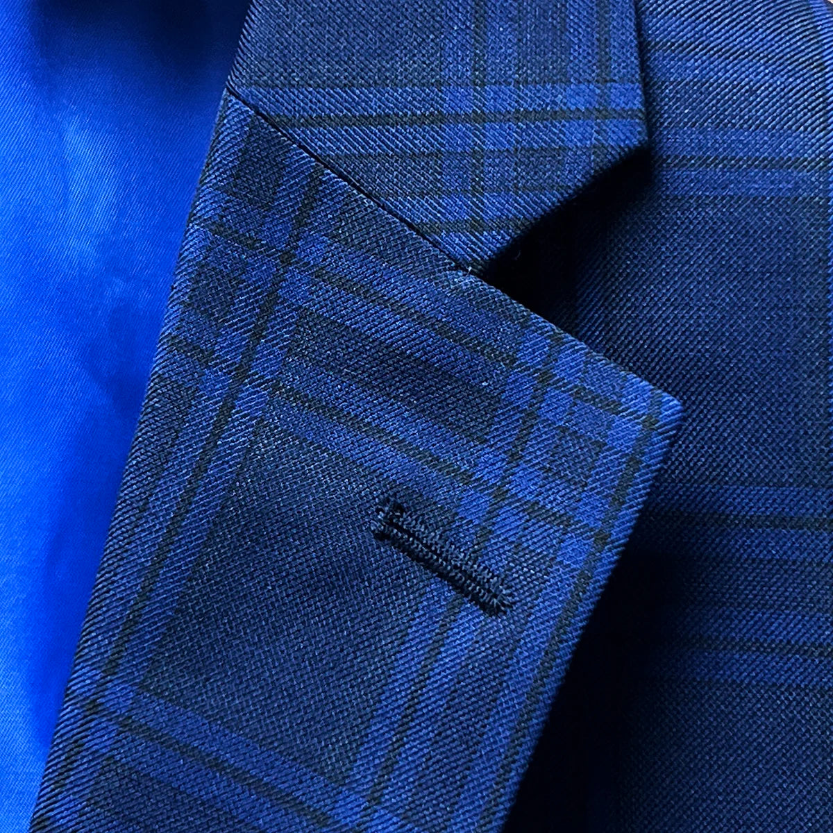 Detail of notch lapel on dark blue Westwood Hart suit jacket with windowpane pattern