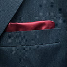 Breast pocket of dark charcoal grey birdseye suit jacket with built-in pocket square holder and hand-finished edges