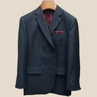 Dark gray suit jacket on a beige background