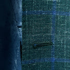 Macro shot of buttonhole stitching on dark green Westwood Hart windowpane sport coat, showcasing precision and craftsmanship