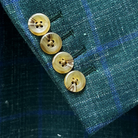 Detail of functional sleeve buttonholes on dark green Westwood Hart windowpane sport coat, demonstrating quality tailoring