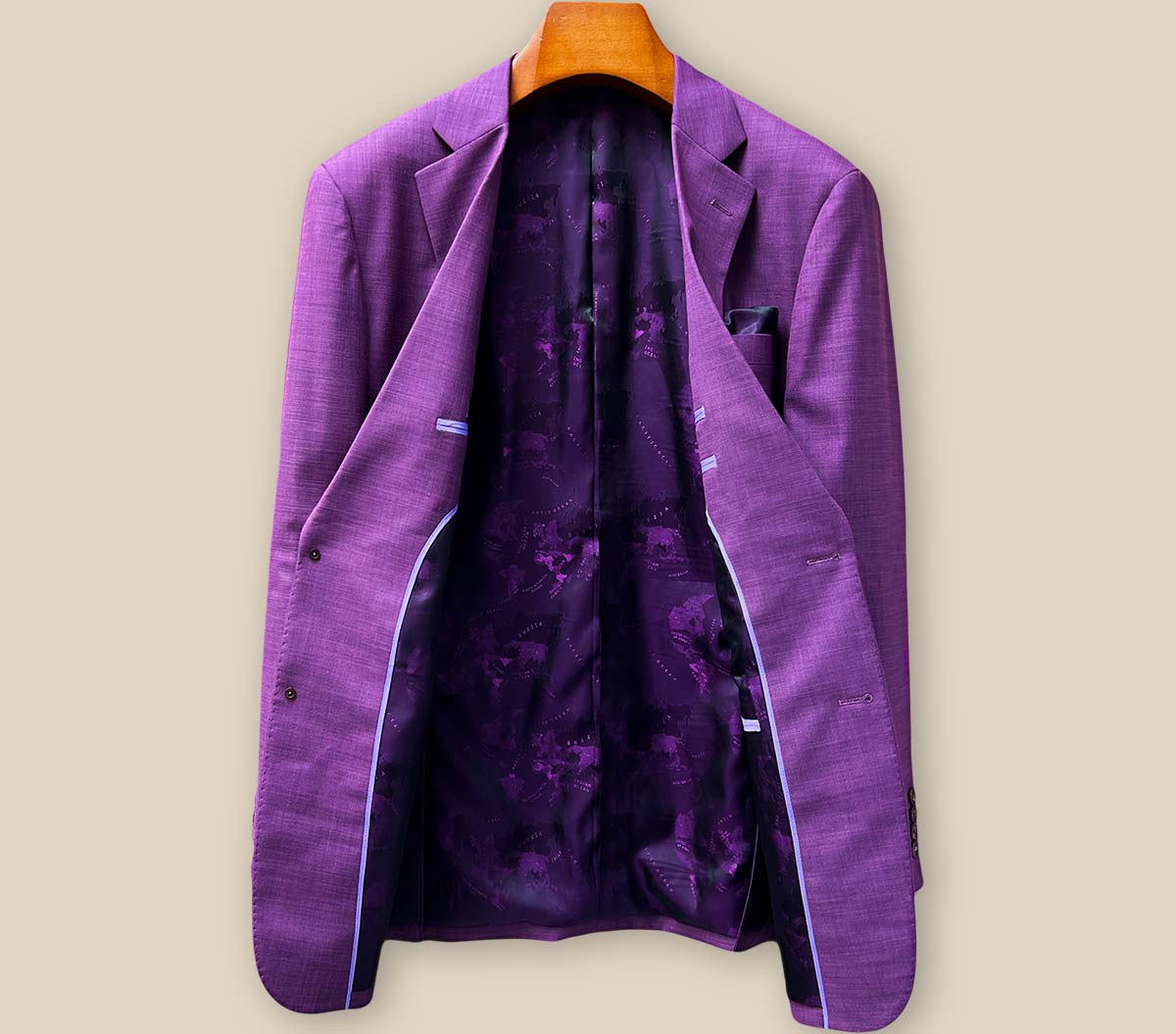 Full interior lining showcase of purple world map pattern in custom sport coat with premium finishing details and silk-like texture