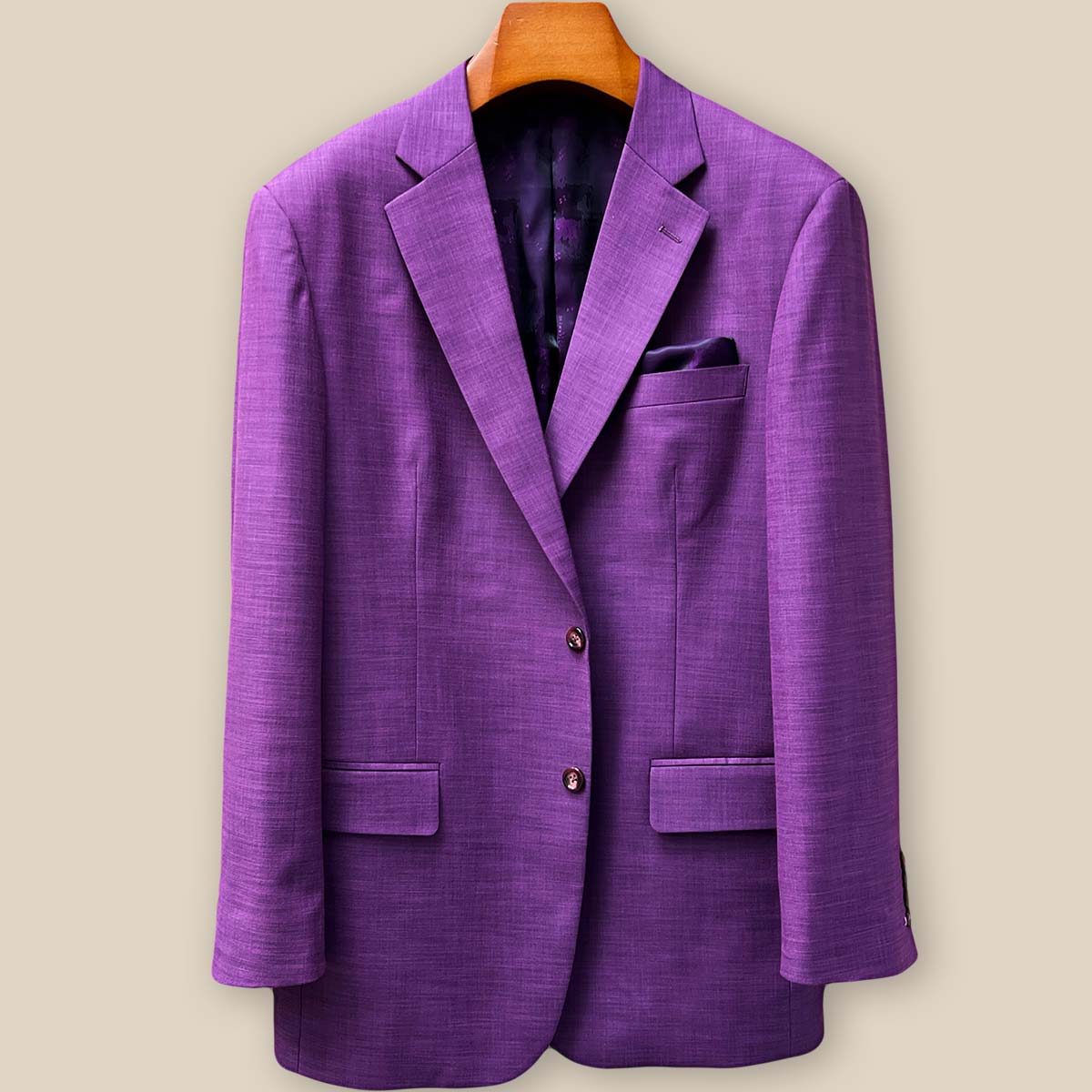 Close-up detail of mulberry horn buttons on dark orchid purple sport coat showing natural texture and premium button selection