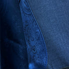 Close-up of a blue denim fabric with intricate stitching detail