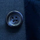 Close-up of a button on blue fabric