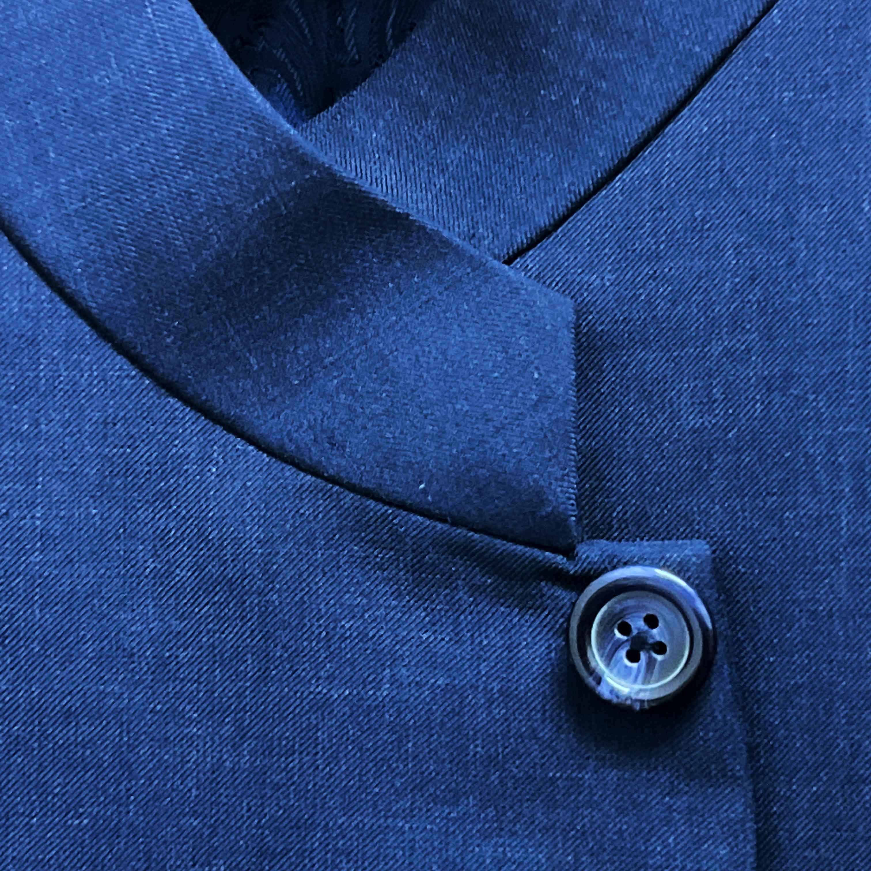 Close-up of a blue button on a garment