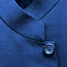 Close-up of a blue button on a garment