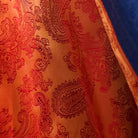 Colorful flash lining detail visible at jacket cuffs and vents in orange paisley jacquard pattern