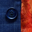Close-up of marbled dark blue horn buttons on deep blue windowpane check suit jacket showing natural marble-like patterns