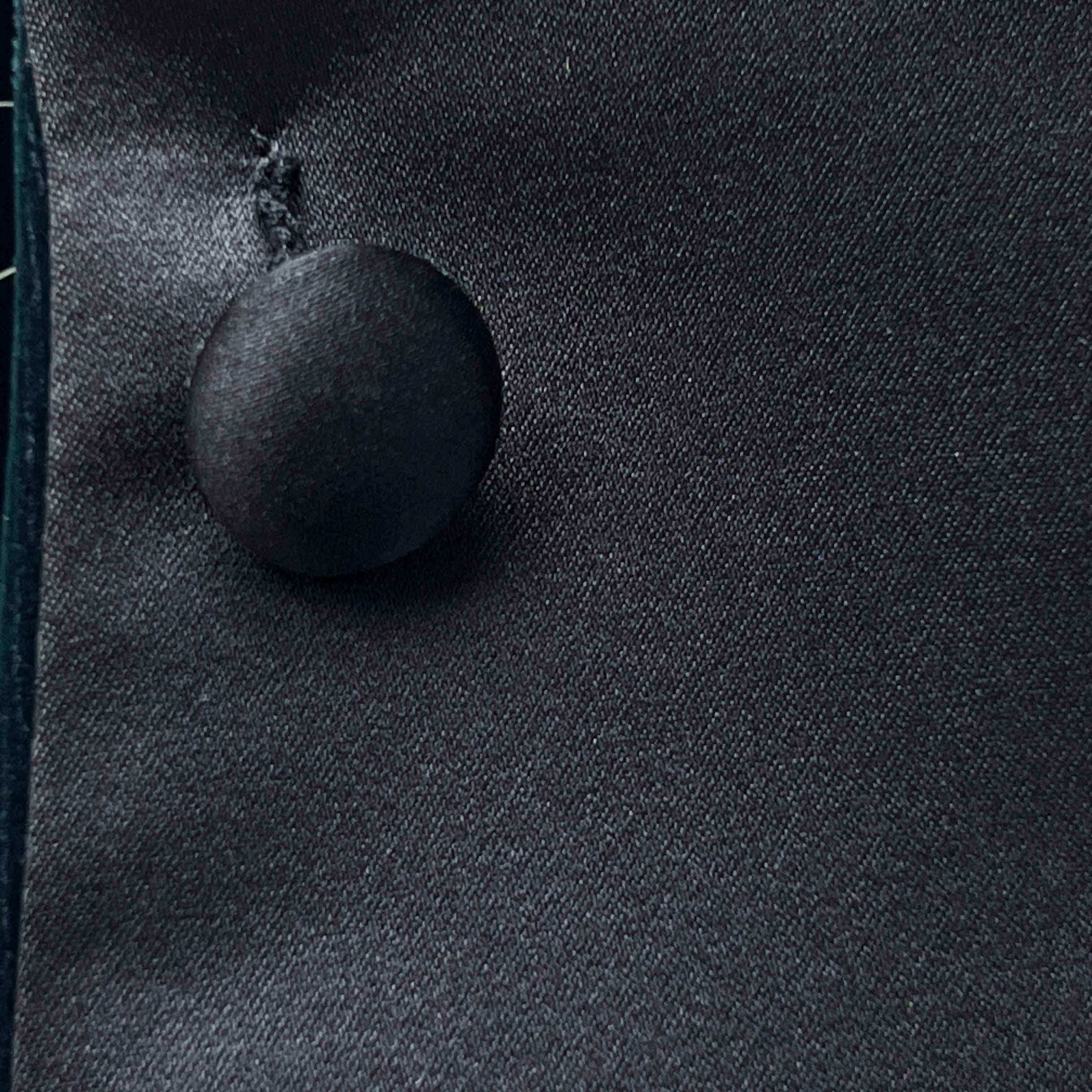 Close-up of a button on a dark fabric surface