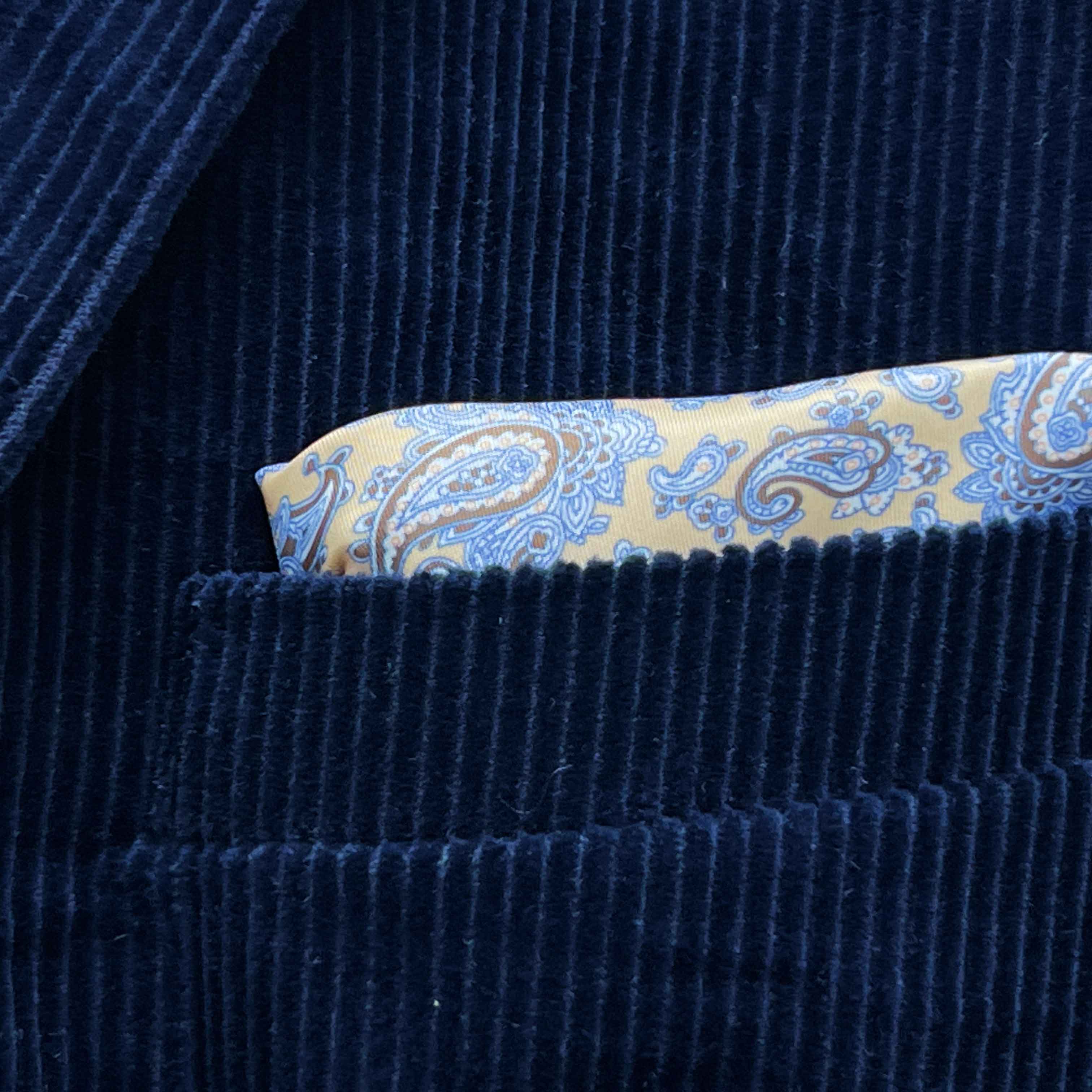 Breast pocket of deep navy blue corduroy sport coat with built-in pocket square holder and hand-finished edges
