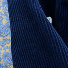 Macro detail of 10-wale corduroy texture in deep navy blue showing the distinctive vertical ribbed pattern