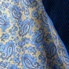 Colorful flash lining detail visible at jacket cuffs and vents in tan with light blue and brown paisley pattern