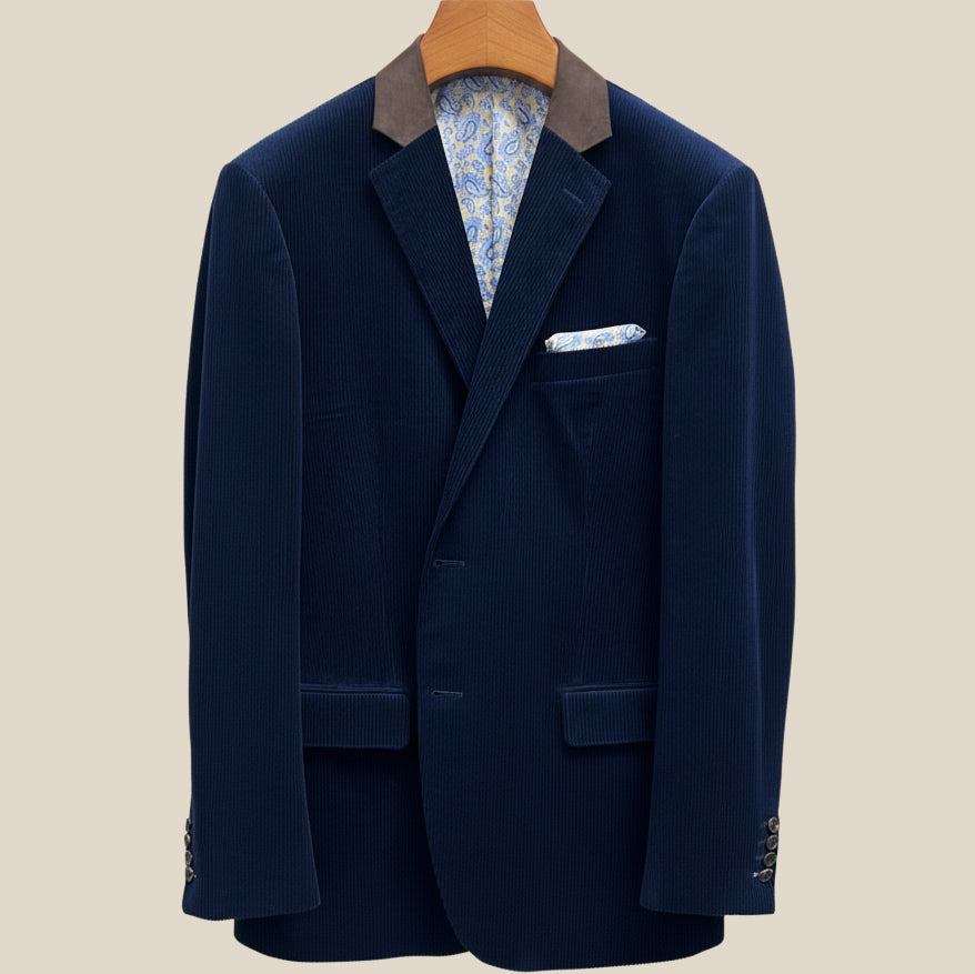 Close-up view of deep navy blue corduroy sport coat showing contrast light blue accent buttonhole with hand-finished stitching detail
