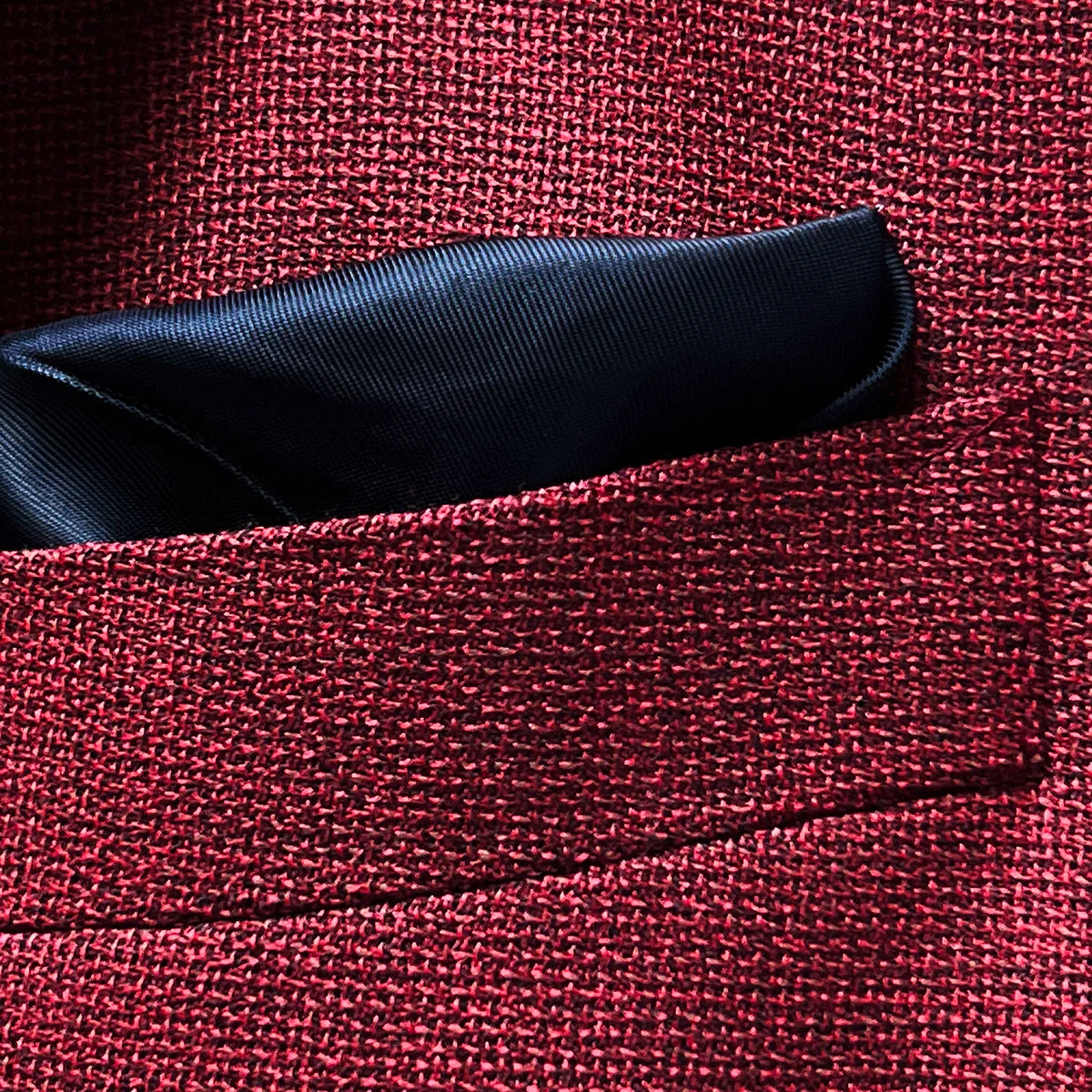 Breast pocket of deep red basketweave sport coat jacket with built-in pocket square holder and hand-finished edges